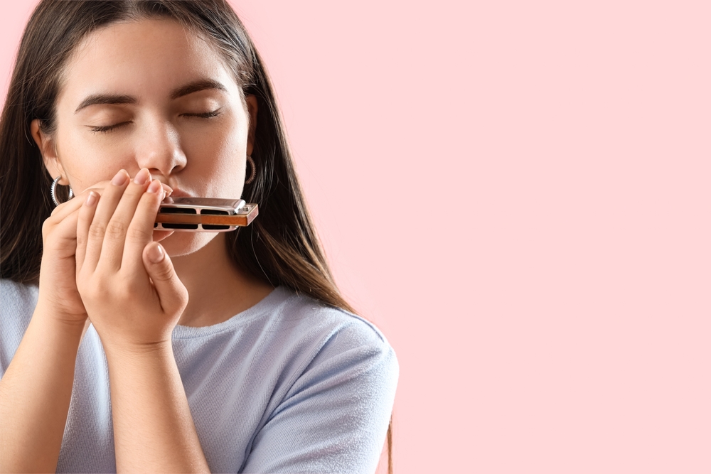 A girl dedicated to learning the harmonica.
