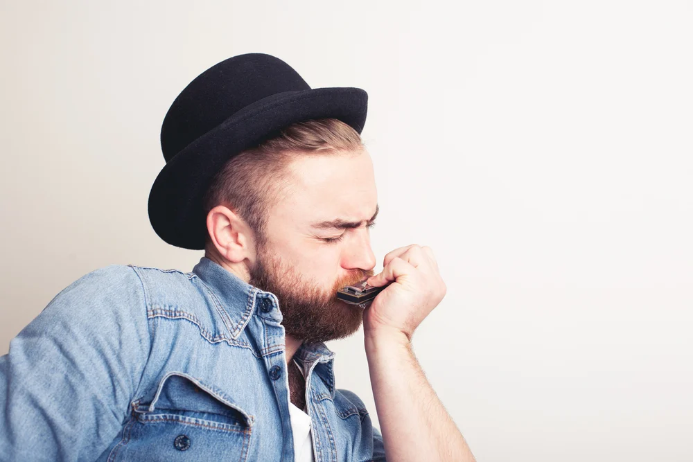 A harmonica student focused on improving and avoiding common harmonica mistakes that beginners often make.